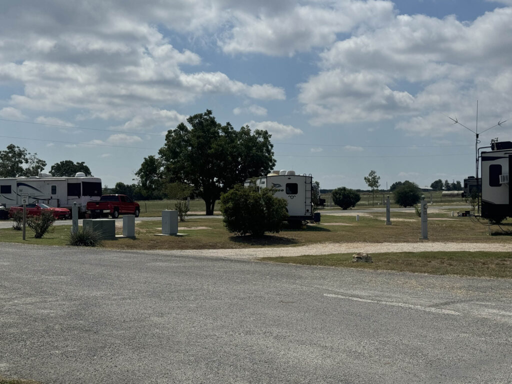 Spacious RV sites with picnic areas and shade trees