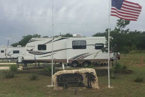 rv sites at Country Oasis RV Park in Georgetown TX American flag waving at an RV site in Florence, TX