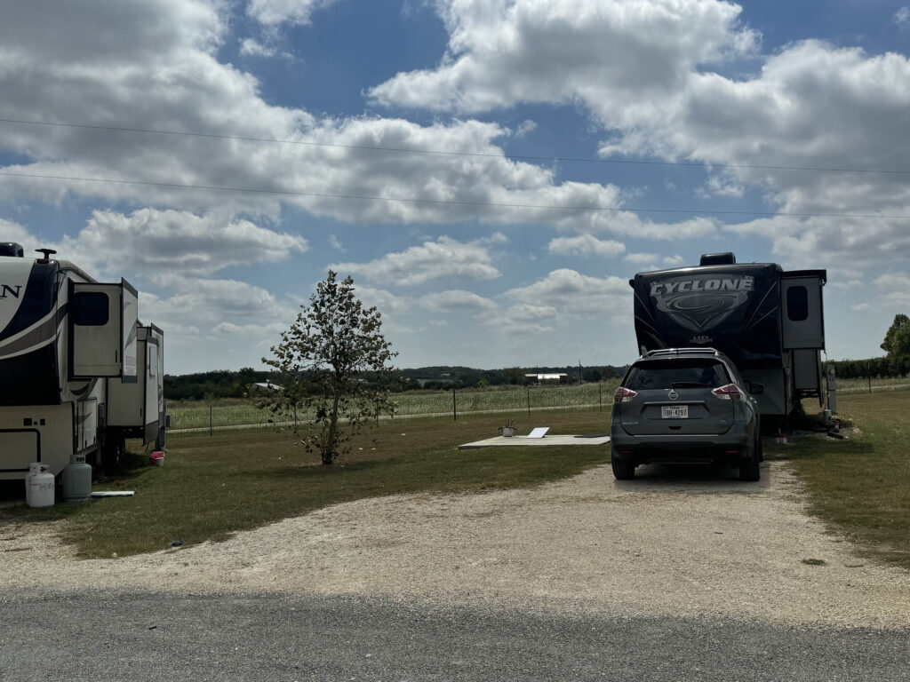 rv sites at Country Oasis RV Park in Georgetown TX RV camper on gravel pad under blue Texas sky