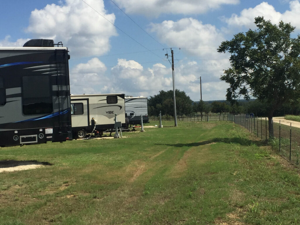 rv sites at Country Oasis RV Park in Georgetown TX Row of parked RVs with shade trees and grassy sites
